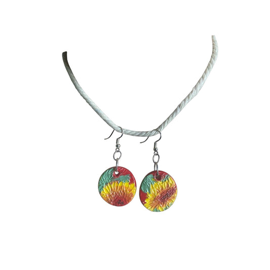 Colorful sunflower-themed earrings on a white background