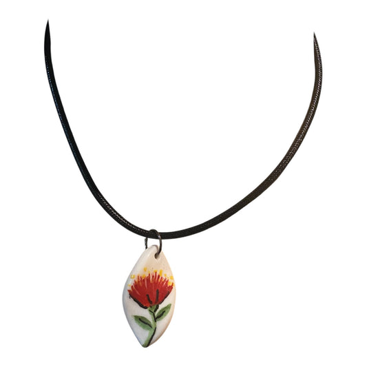 Necklace with a Pohutuukawa flower pendant on a white background