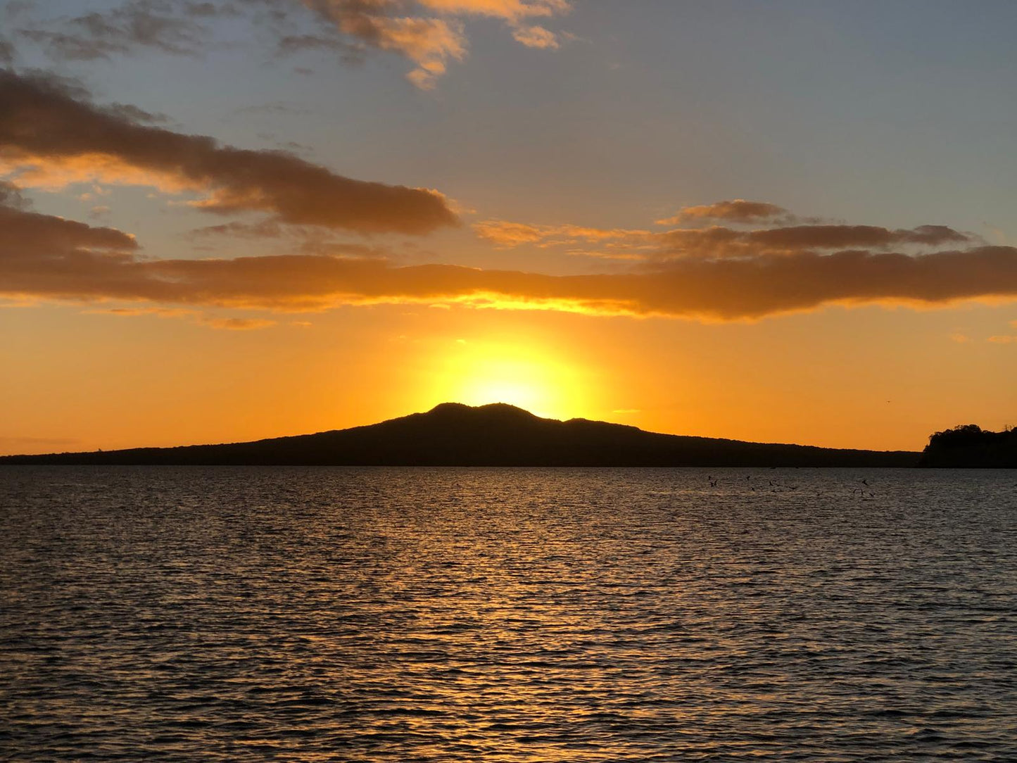 Hand-painted heart decoration depicting two yachts sailing in front of Rangitoto Island, Auckland, New Zealand.