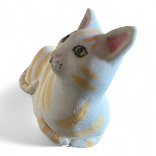 Porcelain Cat figurine with yellow and white stripes on a white background