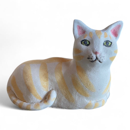 Porcelain Cat figurine with yellow and white stripes on a white background