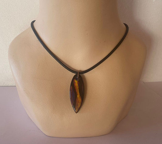 Necklace with a pendant on a mannequin bust against a plain background