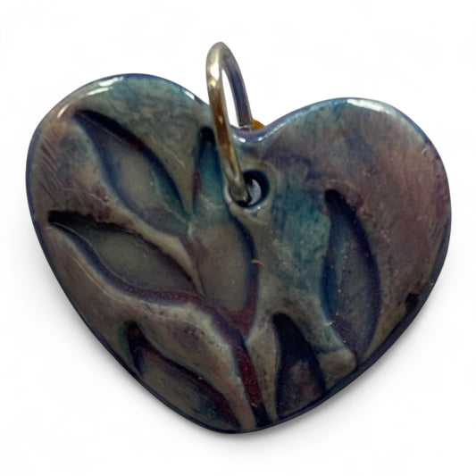 Heart-shaped pendant with marbled design on a white background