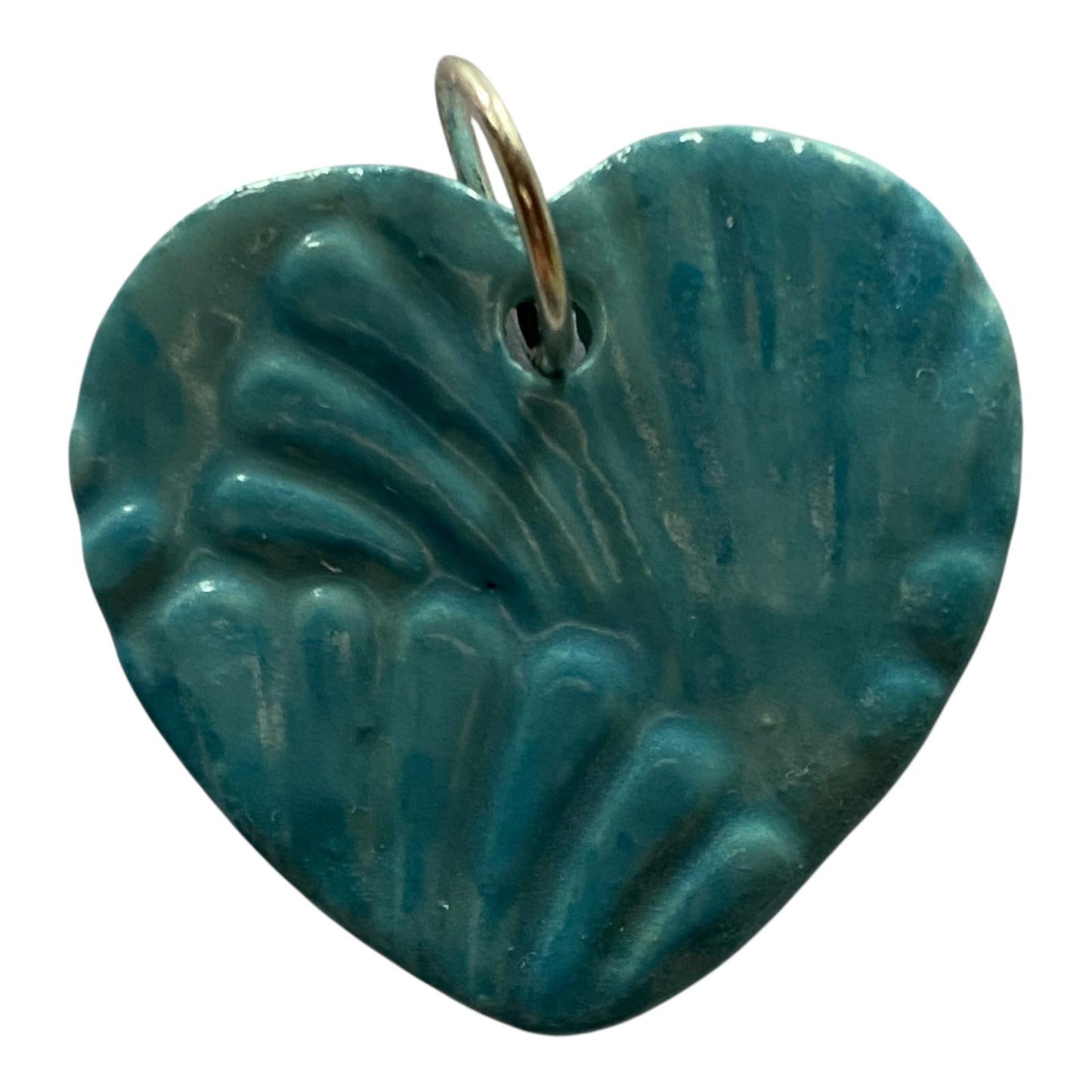 Teal heart-shaped pendant with a textured surface on a white background
