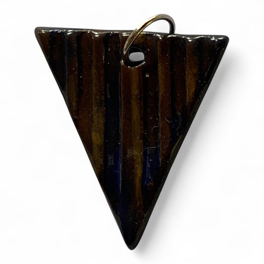 Triangular dark brown ceramic ornament on a white background