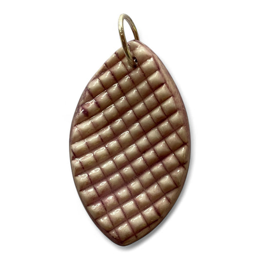 Decorative pendant with woven pattern on a white background