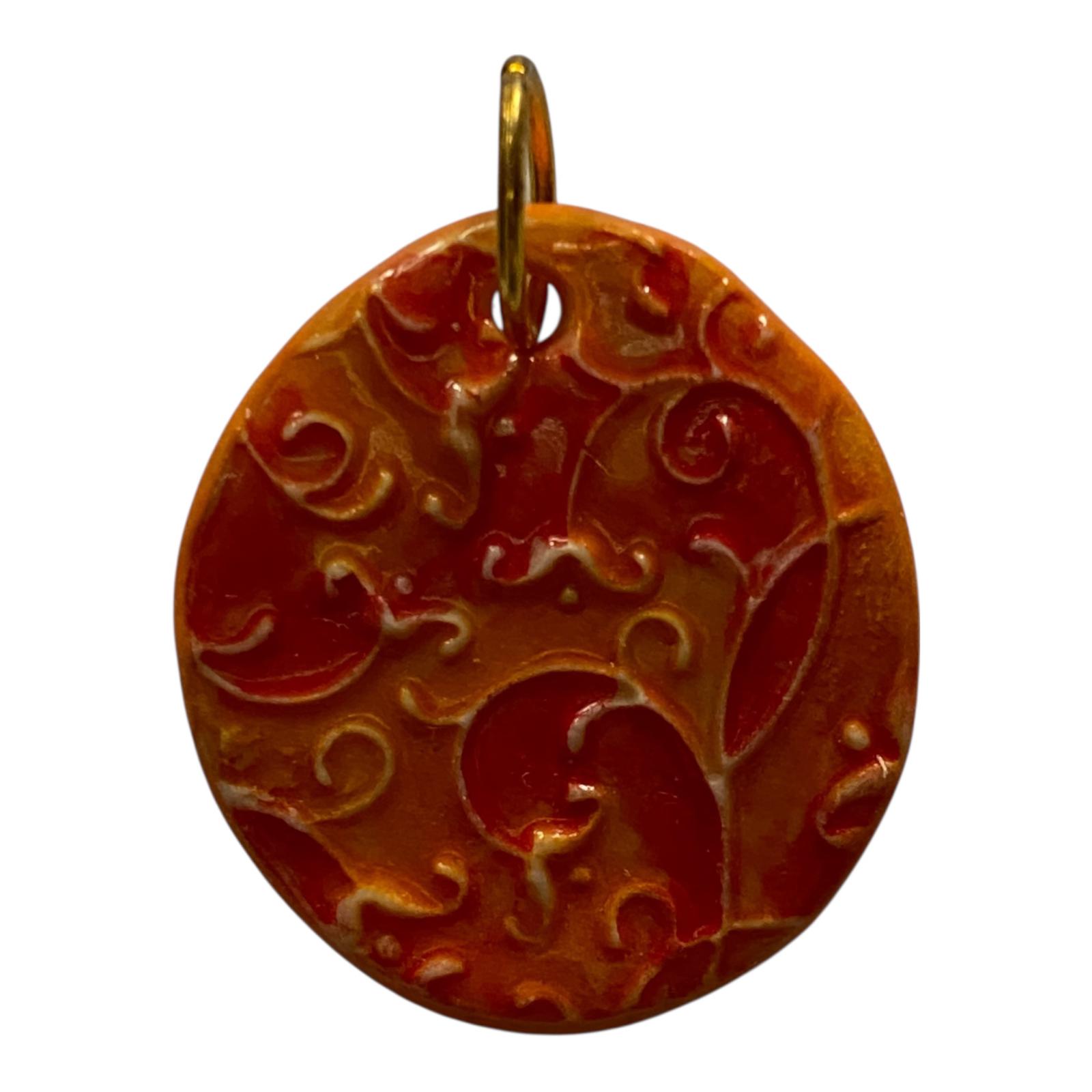 Decorative pendant with intricate patterns on a white background