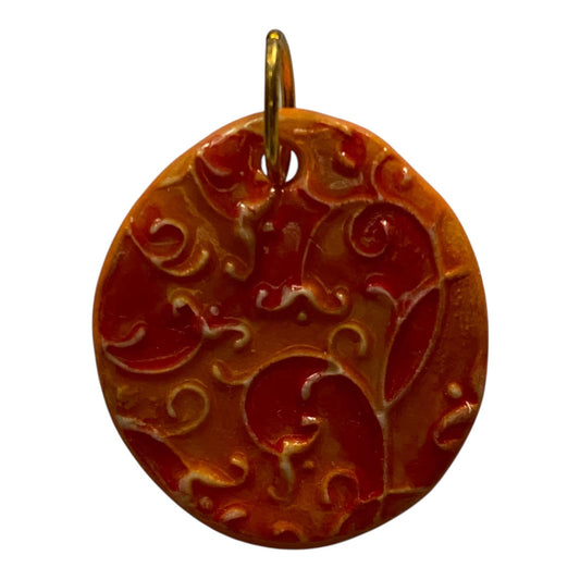 Decorative pendant with intricate patterns on a white background