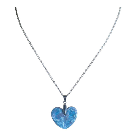 Blue heart-shaped pendant on a silver chain against a white background