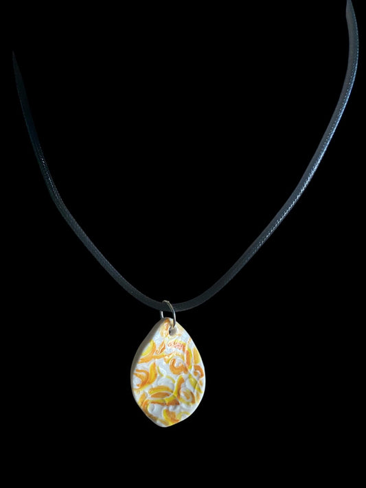 Necklace with a teardrop-shaped pendant on a black background