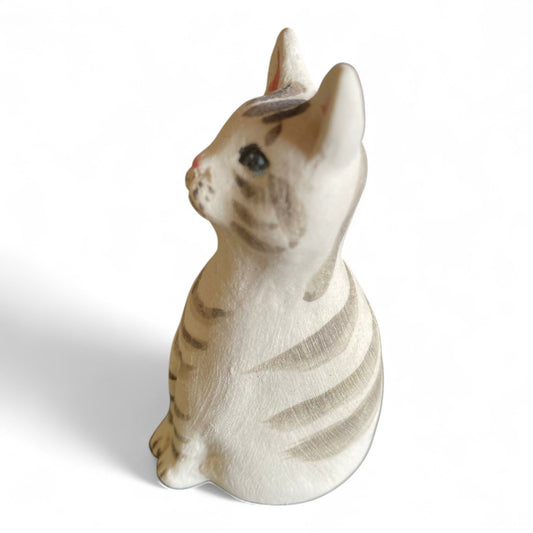 Porcelan stripws cat figurine on a white background