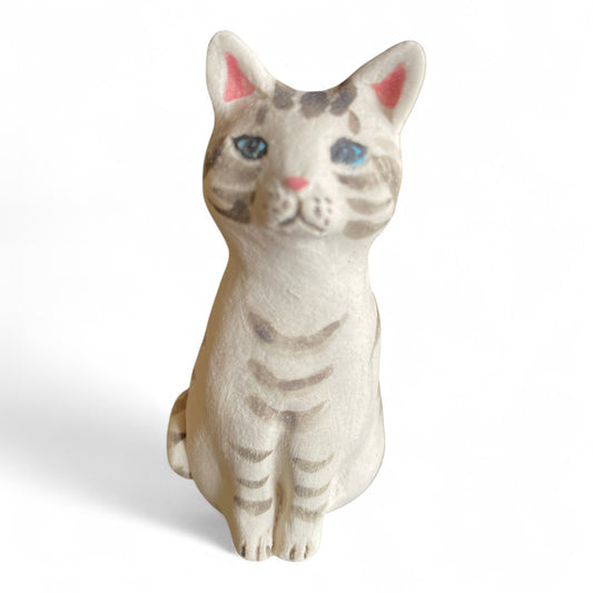 Porcelan stripws cat figurine on a white background