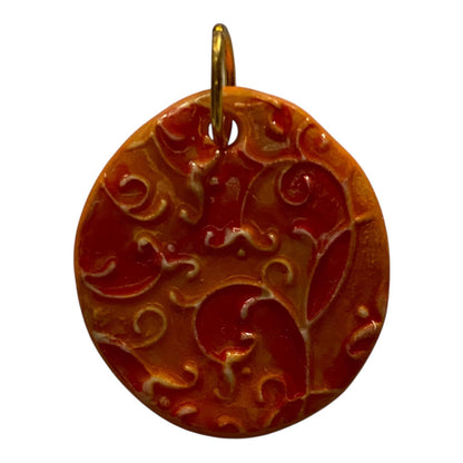 Decorative pendant with intricate patterns on a white background